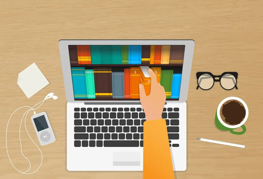 Man chooses eBooks in the Internet store from his laptop placed on the realistic wooden table