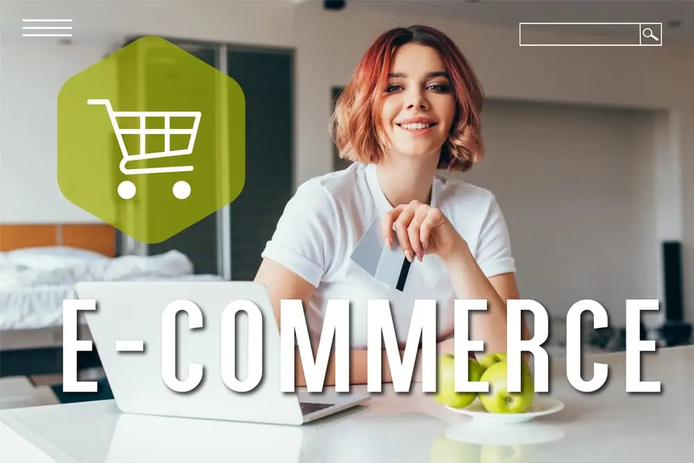 Smiling woman shopping online with laptop and credit cards on kitchen table